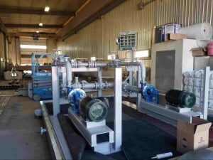 Industrial centrifugal pump skid with aligned motors, piping, and rotating equipment installed in a fabrication facility, illustrating a centrifugal pump alignment procedure for reliable system performance and reduced vibration.